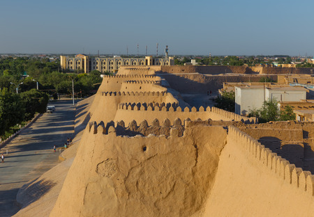 KHIVA, UZBEKISTAN - AUGUST 24, 2016: unidentified people in front of the ancient wall of Khiva, in Uzbekistan.のeditorial素材