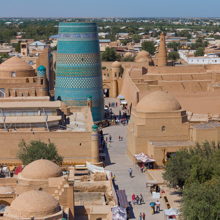 KHIVA, UZBEKISTAN - AUGUST 25, 2016: unidentified people walks near the Kalta Minor Minaret, in the fortress Ichon-Qala, the old town of Khiva, in Uzbekistan.のeditorial素材