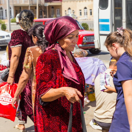 SAMARKAND, UZBEKISTAN - AUGUST 29, 2016: a woman goes shopping at the fruit and vegetable market in Samarkand, Uzbekistanのeditorial素材