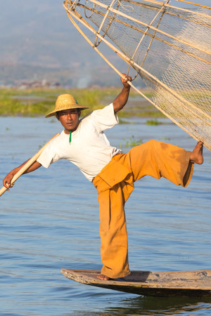 INLE LAKE, MYANMAR - NOVEMBER 30, 2014: Fisherman of Inle Lake in action when fishing, in Myanmarのeditorial素材
