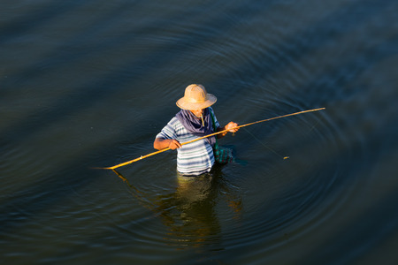 AMARAPURA, MYANMAR - NOVEMBER 23, 2014: fishermen near the Bein? ? ?,?? "? s Bridge, the longest teak footbridge of the world, in Amarapura, near Mandalay, Myanmarのeditorial素材