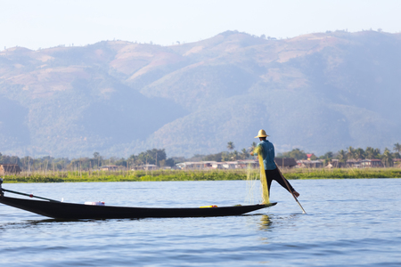 INLE LAKE, MYANMAR - NOVEMBER 30, 2014: Fisherman of Inle Lake in action when fishing, in Myanmarのeditorial素材