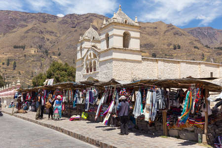 Maca, Peru - september 26, 2018: market of artisan products and handmade textiles in front of Church...