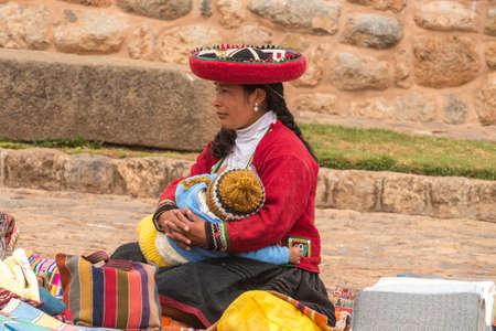 Chinchero, Peru - october 05, 2018: saleswoman in the local market with handmade alpaca textile products and souvenirs in Chinchero, Peruのeditorial素材