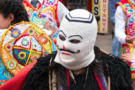 Cusco, Peru - october 08, 2018: People take part in the religious parade of the Virgin of the Rosary and walk in the historic center of Cusco in traditional masks and dresses, in Cusco, Peru.のeditorial素材