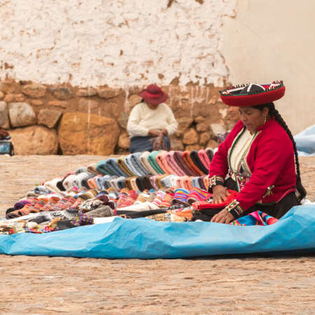 Chinchero, Peru - october 05, 2018: saleswoman in the local market with handmade alpaca textile products and souvenirs in Chinchero, Peruのeditorial素材