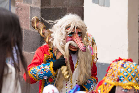 Cusco, Peru - october 08, 2018: People take part in the religious parade of the Virgin of the Rosary and walk in the historic center of Cusco in traditional masks and dresses, in Cusco, Peru.のeditorial素材