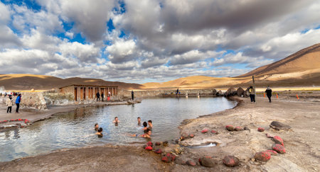 San Pedro de Atacama, Chile - october 14, 2019: people relax with a bath in a Natural hot spring pool at an altitude of 4300m, El Tatio Geysers, Atacama desert, Chile, South Americaのeditorial素材