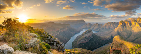 The Blyde River Canyon, a 26 km long Canyon in Mpumalanga, South Africa. On the right the Three Rondavels, three mountains very similar to the traditional African homesteads called rondavelsの写真素材