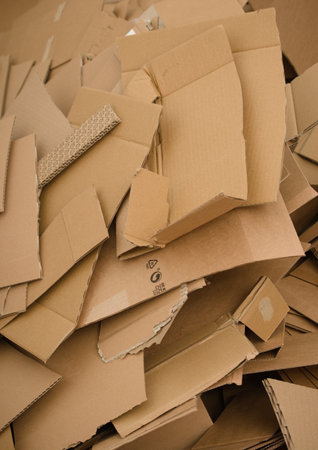 A lot of cut cardboard lying in a large pile. Photo shows the amount of the waste generated by the cardboard packaging.の写真素材