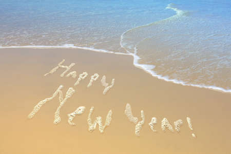 New Year sign made of foam on the sand  beach