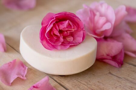 White soap pink camellia flowers petals wooden tableの写真素材