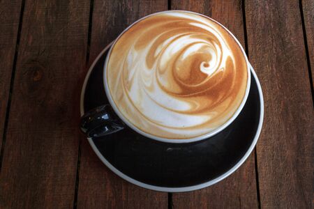 Latte art coffee cup  of on wooden table background