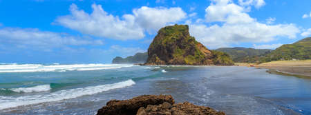 Panoramic view of Piha Beach with Lion Rock, New Zealand