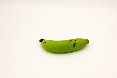 The green bananas on a white background.の写真素材