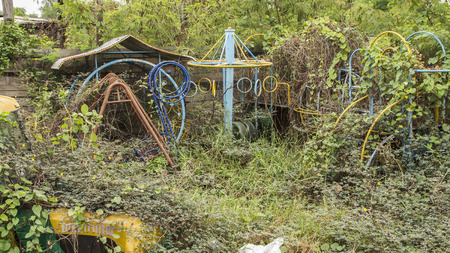 Old toys abandoned. There are many covered trees.の写真素材