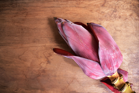 Banana flower on wooden texture background.の写真素材