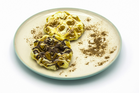 White and dark waffles on isolated white background.の写真素材