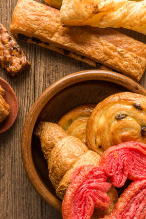 Bakery variety of style and flavors on a wooden table.の写真素材