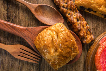 Bakery variety of style and flavors on a wooden table.の写真素材