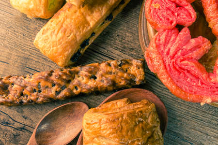 Bakery variety of style and flavors on a wooden table.