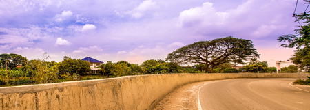 Landscape of  Road with a barrier wall and trees in blue sky on summer season,Panorama.の写真素材