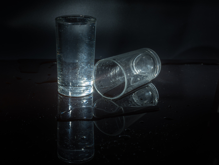 Water splash and crystal glass on black background.の写真素材