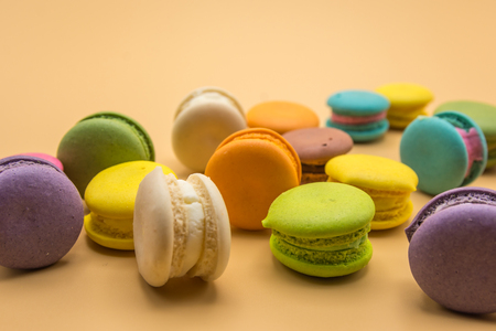 Colorful Macaron sweet and delicious on cream color background.の写真素材