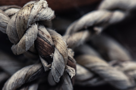 Close-up End of vintage rope on dark background.