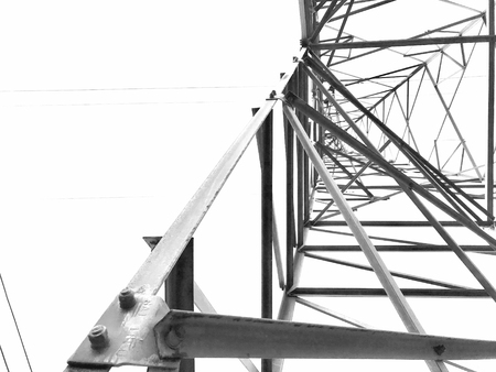 High voltage electricity tower close-up structure in black and white on white background.