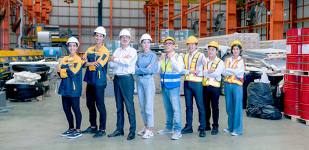 Portrait of confident team of factory workers standing in warehouse. Transportation and distribution...