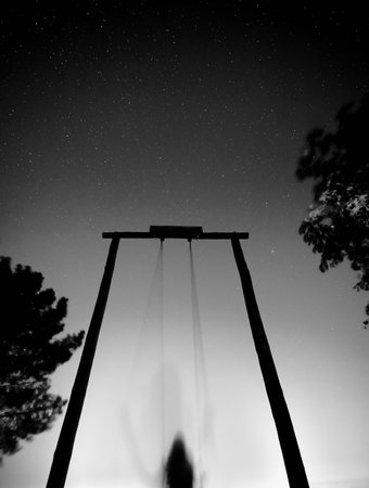 Suspension bridge in the night sky. Black and white photo.の写真素材