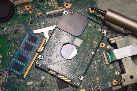 Image of a technician screwing the back of a mobile phone.の写真素材