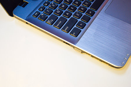 side view left side of laptop on a white background and using yellow-orange lightの写真素材