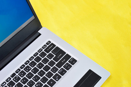 top right view of white laptop on yellow backgroundの写真素材