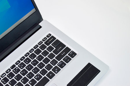 top right view of a white laptop on a white backgroundの写真素材