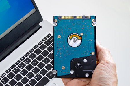 Hard disk drives are still widely used, hard drives in hand.の写真素材