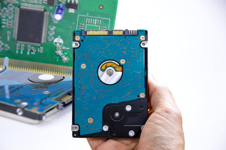 Hard disk drives are still widely used. hard drive in hand (Cut path included in this picture)の写真素材