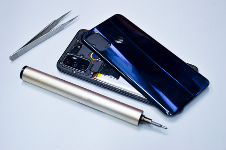 A picture of a smartphone being unpacked for repair. put on a white backgroundの写真素材