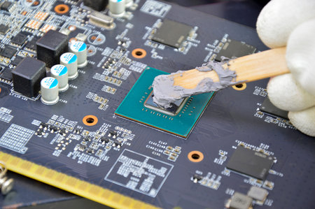 The image of a technician filling a silicon cooling chip CPU.の写真素材