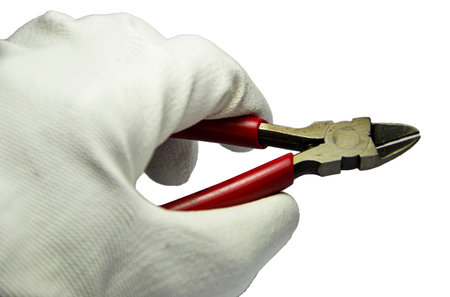 Hand holding the red cutting pliers (with clipping path)の写真素材