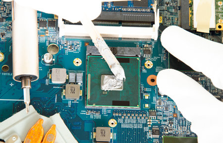 Looking at the picture above, CPU, computer motherboard, electronic motherboard repair.の写真素材