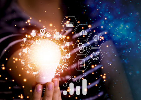hand holding a light bulb icon Creativity and innovation are the keys to success. New ideas and...