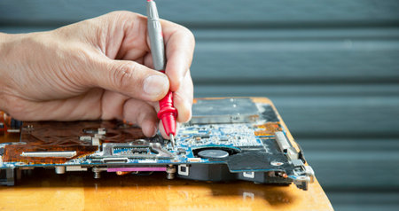 side view mechanic repairing motherboardの写真素材