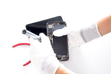 top view, technician fixing a smartphoneの写真素材