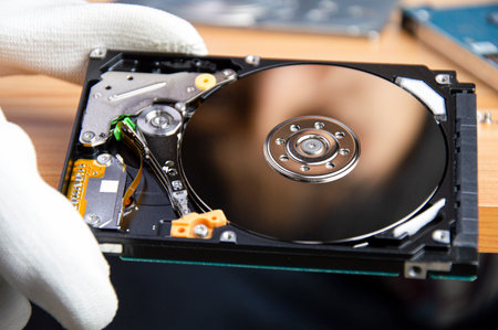 mechanic repairing hard drive, hard drive It is a device for storing data.の写真素材