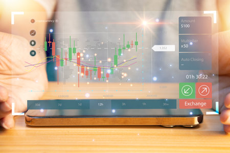 Businessman working with smartphone and virtual graphs, closeup. Financial trading conceptの写真素材