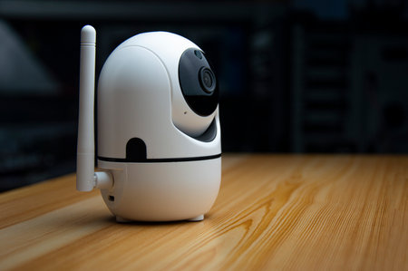 White IP camera placed on wooden floorの写真素材