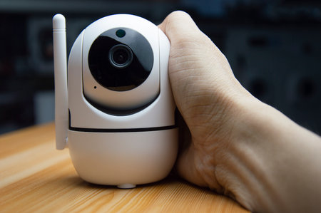 White IP camera placed on wooden floorの写真素材