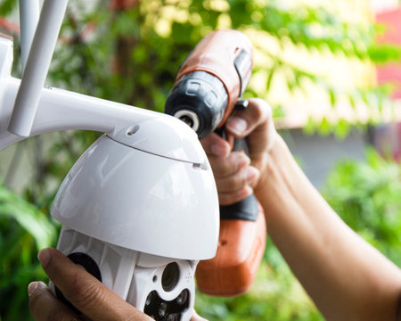 Man installing IP CCTV or high tech surveillance system CCTV systemの写真素材